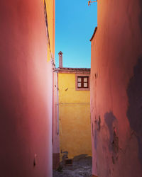 Walking through narrow alley with colorful houses in sardinia, italy