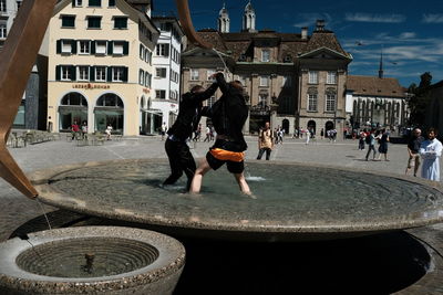 People fighting in fountain