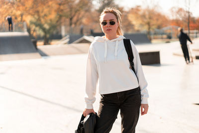 Young woman wearing sunglasses standing outdoors