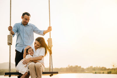 Rear view of woman swinging at playground