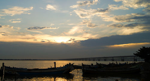 Boats moored at sunset