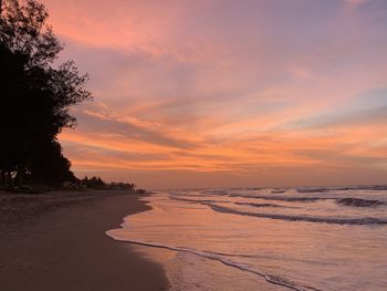 Scenic view of beach against sky during sunset