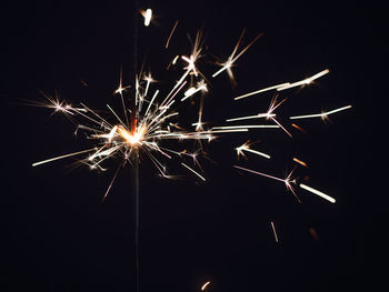 Low angle view of firework display at night