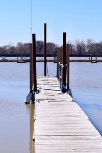 Wooden pier over lake against sky during winter