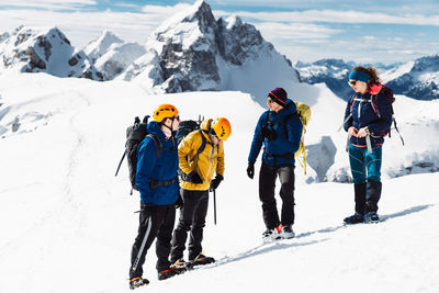 People skiing on snowcapped mountain