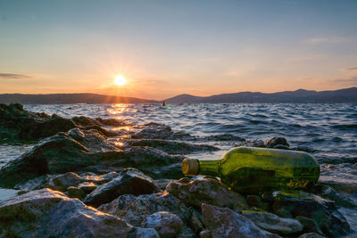 Scenic view of calm sea at sunset