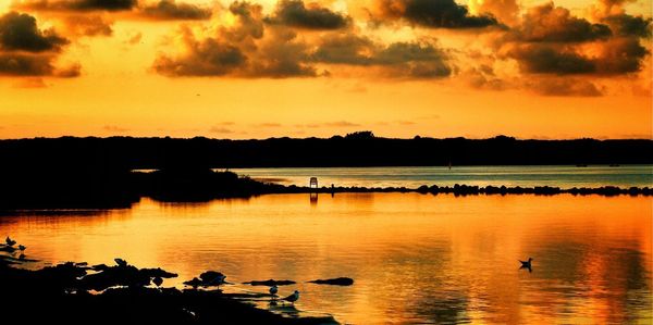 Scenic view of lake at sunset