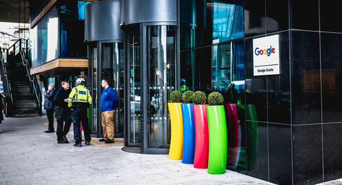 People standing on multi colored umbrellas