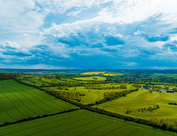 Scenic view of agricultural landscape against sky