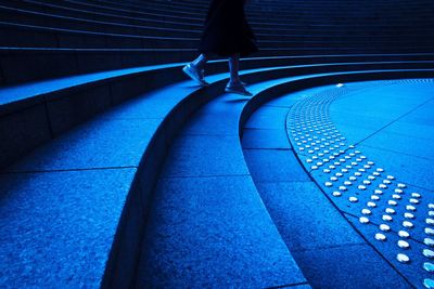 Low section of woman walking on steps