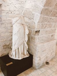 Statue of buddha against wall