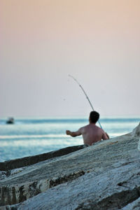 View of man fishing in sea