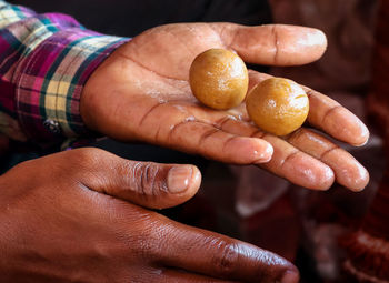 Cropped hand of person holding fruit