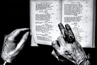 Cropped image of hands with book in room