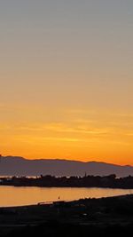 Scenic view of sea against orange sky