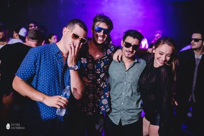 Young couple dancing in illuminated nightclub