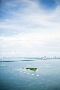 Aerial view of biscayne bay against cloudy sky