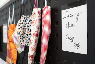 Close-up of clothes hanging on wall in store