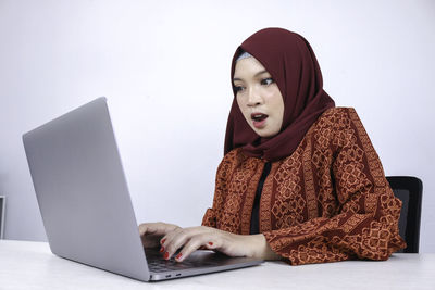 Low angle view of young woman using mobile phone