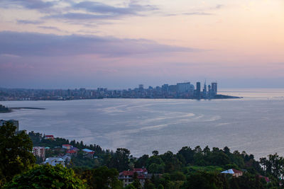 High angle view of buildings by sea against sky