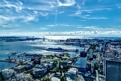 High angle view of buildings by sea against sky