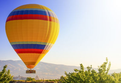 Cappadocia yellow hot air balloon at sunrise