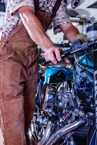 Man holding motorbike