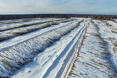 Snow covered land against sky