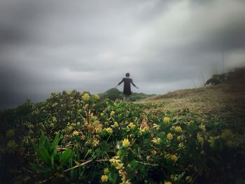 Scenic view of field against cloudy sky