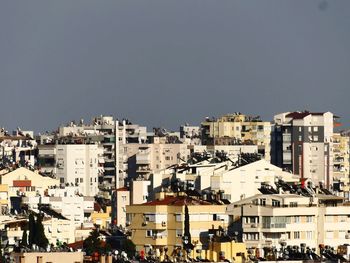 Buildings in city against clear sky