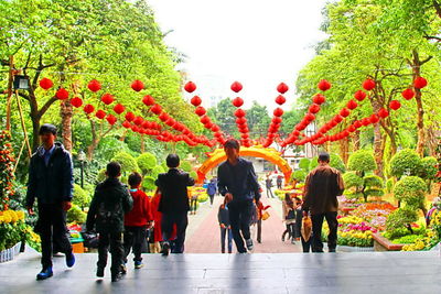 Rear view of people holding balloons