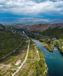 High angle view of road by land against sky