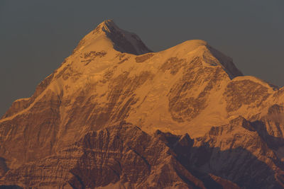 Scenic view of snowcapped mountains against sky during sunset 