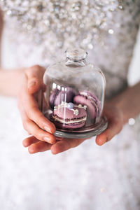 Midsection of woman holding glass
