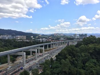 Bridge over river against cloudy sky