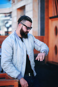 Man checking time while standing outdoors