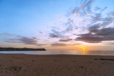 Scenic view of beach against sky during sunset