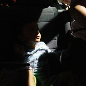 Close-up of siblings sitting in car