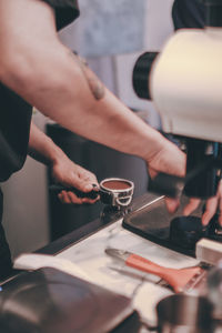 Midsection of man working with coffee