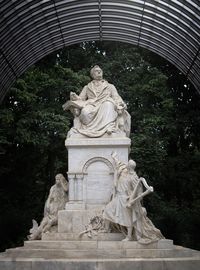 Statue against trees