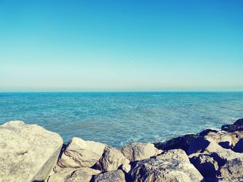 Scenic view of sea against clear blue sky