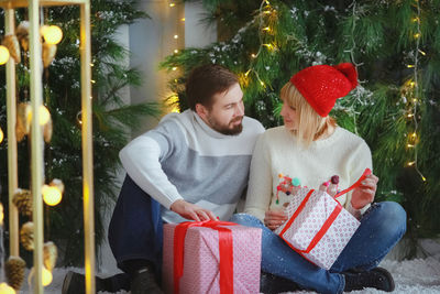 Side view of mother and daughter sitting at home