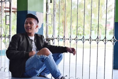 Portrait of young man sitting outdoors