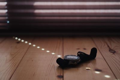 Close-up of wristwatch on wooden floor