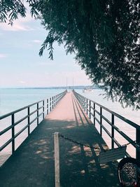 Footpath by sea against sky