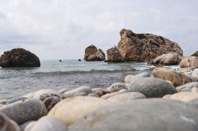 Rocks on beach against sky