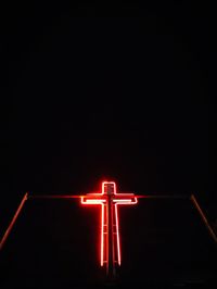 Low angle view of illuminated light against dark sky
