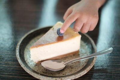 Close-up of person holding ice cream on table