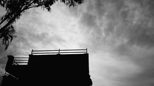 Low angle view of building against cloudy sky