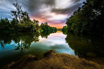 Scenic view of lake against cloudy sky